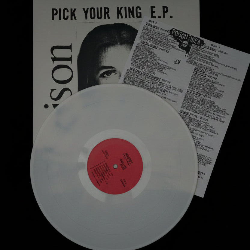 Clear vinyl record with pink label on a textured surface